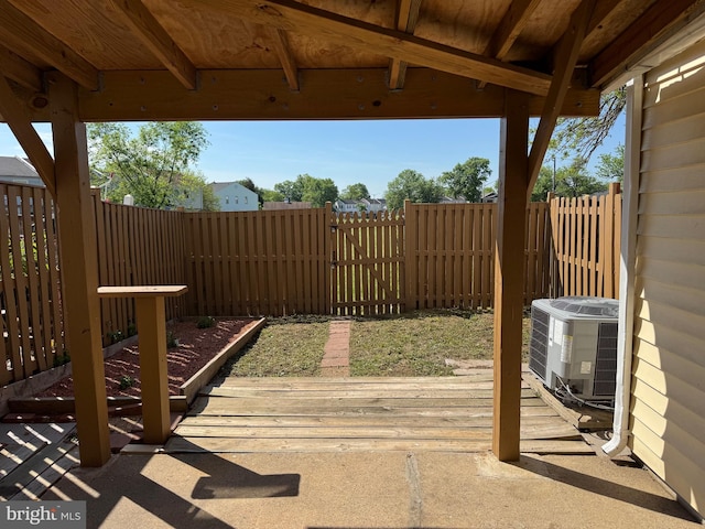 view of patio / terrace featuring central air condition unit, fence, and a gate