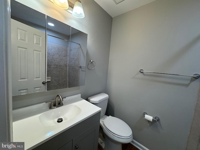 bathroom with toilet and vanity