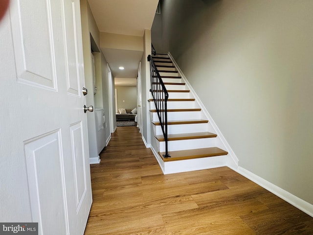 stairs featuring baseboards, recessed lighting, and wood finished floors