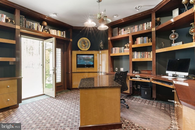 carpeted home office with built in study area and built in shelves