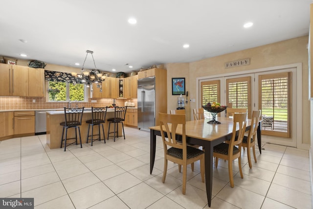 dining area featuring light tile patterned flooring, a notable chandelier, and recessed lighting