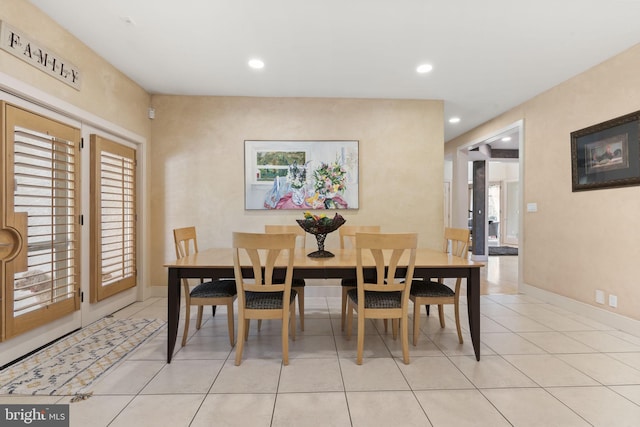 dining area with light tile patterned flooring, baseboards, and recessed lighting