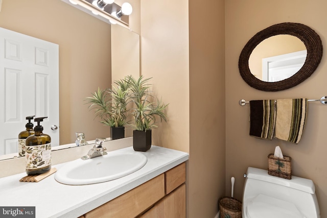 bathroom featuring toilet and vanity