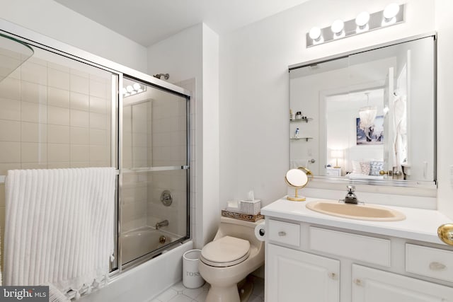 full bathroom featuring connected bathroom, vanity, tile patterned flooring, toilet, and bath / shower combo with glass door