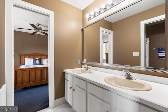 bathroom featuring a sink, tile patterned floors, ceiling fan, and double vanity