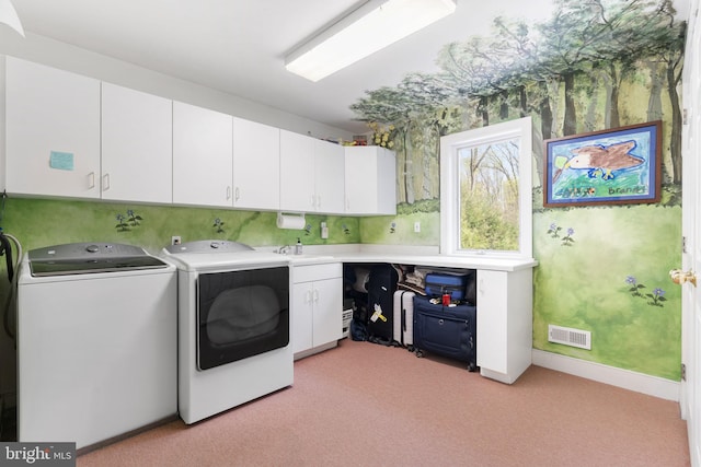 laundry area with washer and dryer, light carpet, visible vents, and cabinet space