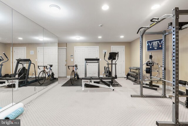 exercise room with baseboards, recessed lighting, and carpet