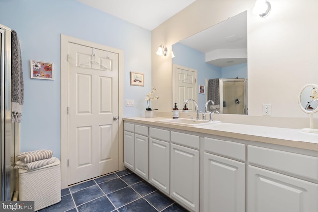 bathroom featuring tile patterned flooring, a stall shower, and vanity