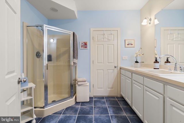 full bathroom featuring tile patterned flooring, a stall shower, and vanity