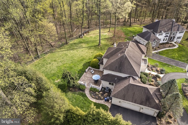 bird's eye view with a wooded view
