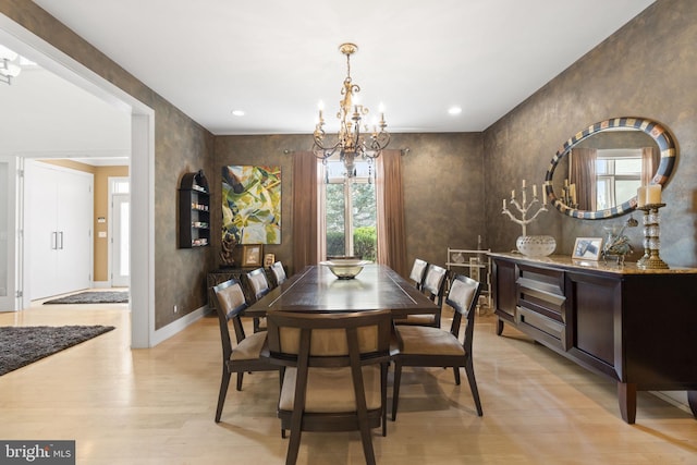 dining space featuring light wood-style floors, recessed lighting, a notable chandelier, and baseboards