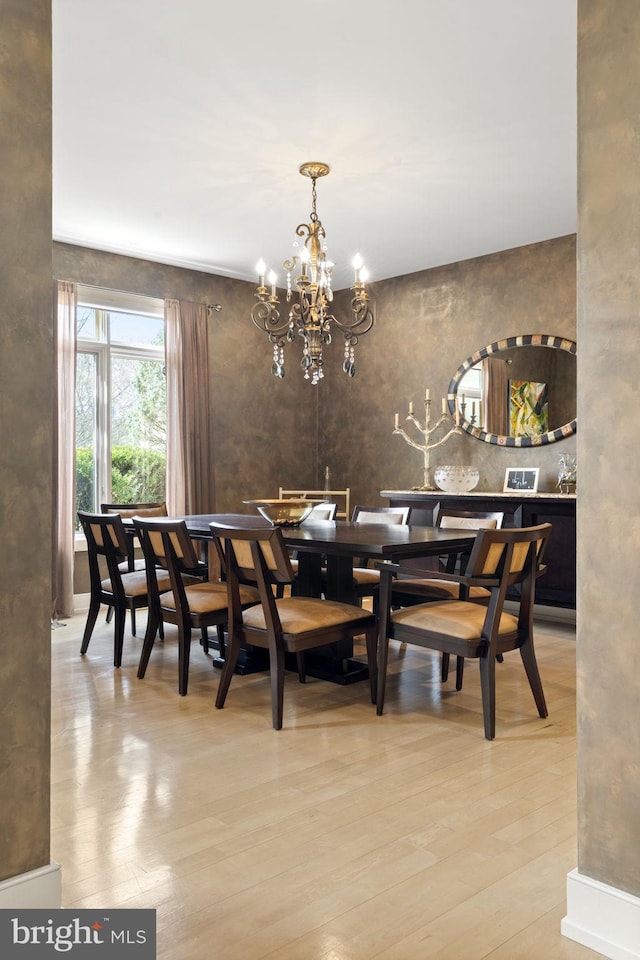 dining space featuring a notable chandelier and wood finished floors