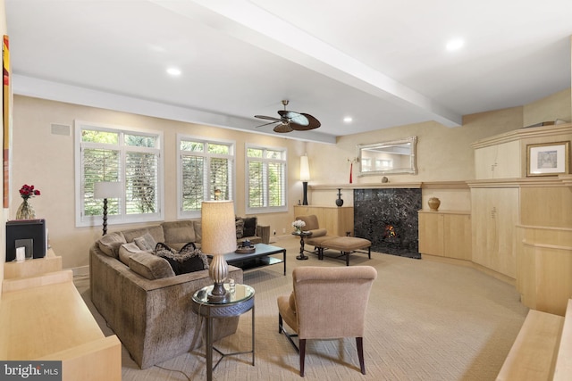 living room with a premium fireplace, light colored carpet, beam ceiling, and recessed lighting