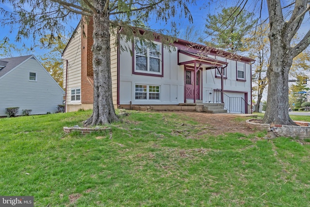 bi-level home featuring an attached garage and a front lawn