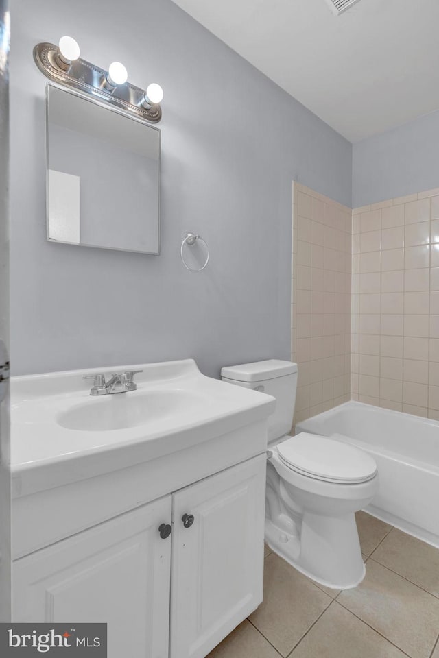 full bathroom featuring toilet, vanity, and tile patterned floors