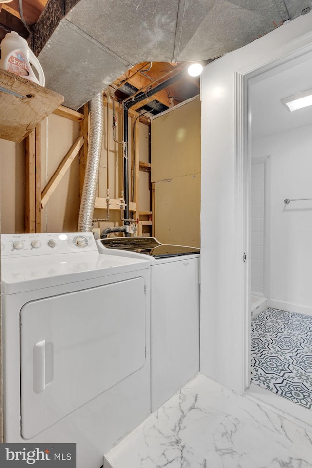 laundry room with separate washer and dryer, baseboards, and laundry area
