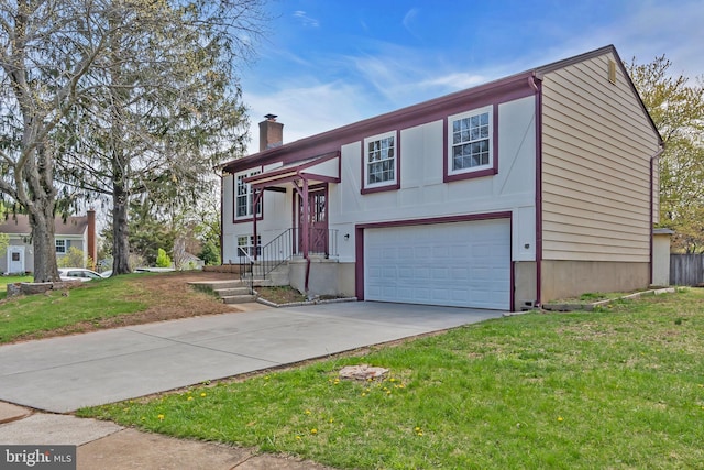 split foyer home featuring a chimney, driveway, a front yard, and a garage