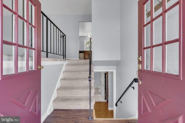 entryway featuring wood finished floors and stairs