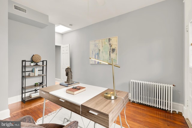 3218 13th St NW, Washington, DC 20010 - home office with radiator heating unit, baseboards, wood finished floors, and visible vents