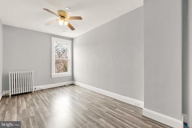 3218 13th St NW, Washington, DC 20010 - empty room featuring a ceiling fan, baseboards, radiator heating unit, and wood finished floors