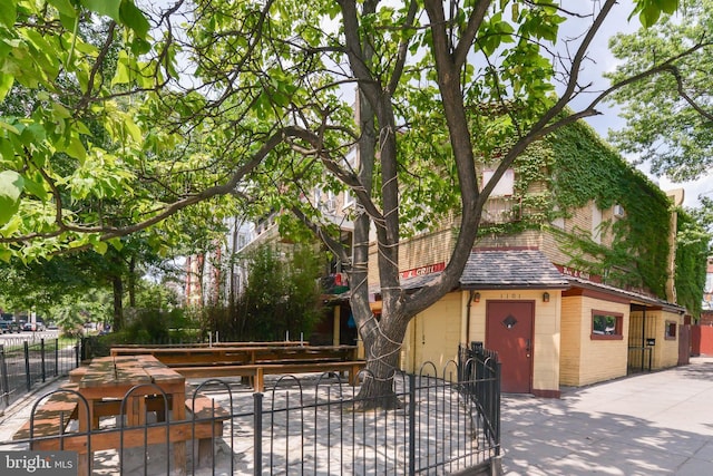3218 13th St NW, Washington, DC 20010 - exterior space with concrete block siding, a shingled roof, and a fenced front yard