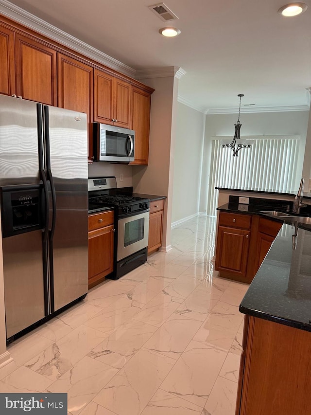 kitchen featuring an inviting chandelier, ornamental molding, brown cabinets, appliances with stainless steel finishes, and a sink