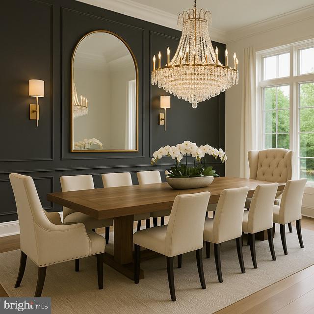 9210 Marseille Dr, Potomac, MD 20854 - dining area with a chandelier, a decorative wall, light wood-type flooring, and ornamental molding