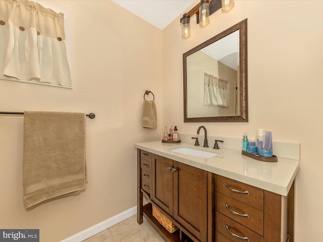 bathroom with tile patterned floors, vanity, and baseboards