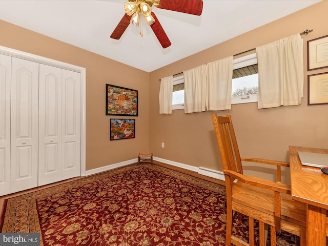 unfurnished office featuring baseboard heating, baseboards, and a ceiling fan