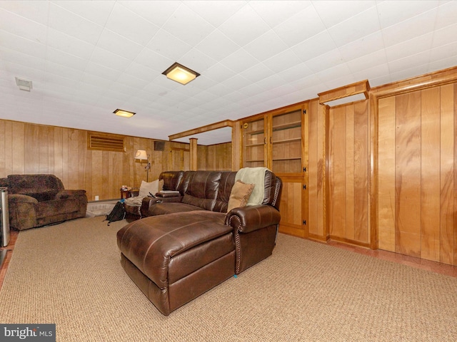 living area with wood walls and carpet flooring