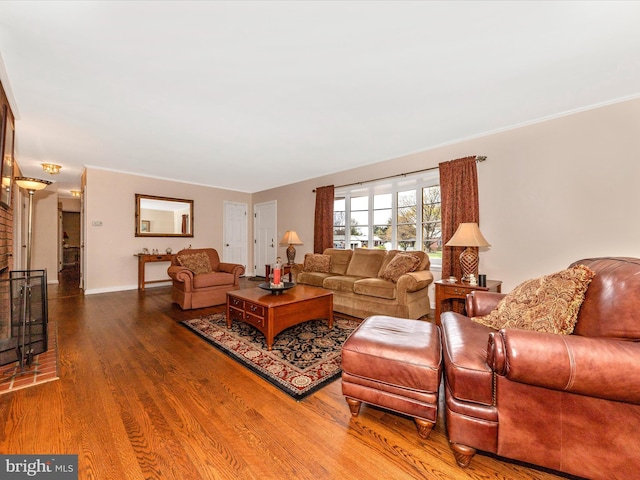 living area featuring baseboards and wood finished floors