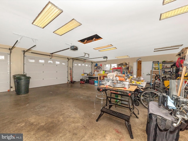 garage featuring a garage door opener and a workshop area