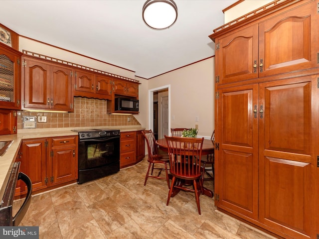 kitchen with black microwave, light countertops, brown cabinetry, decorative backsplash, and electric range oven