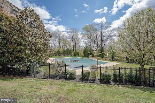 view of swimming pool with fence, a yard, and a fenced in pool