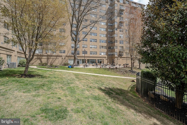 surrounding community with fence and a lawn