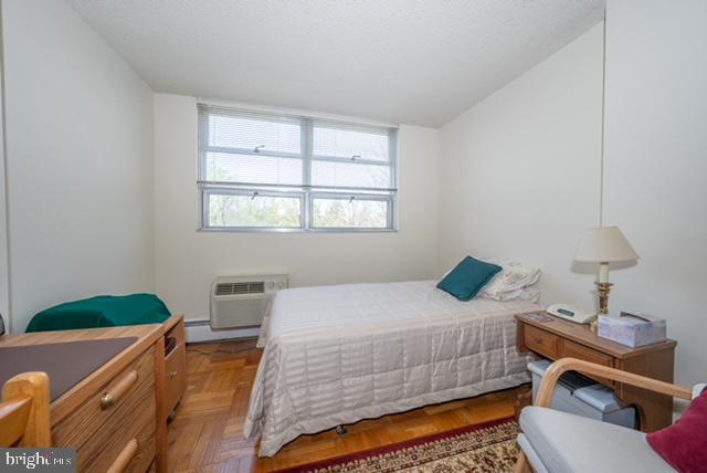 bedroom with a wall unit AC