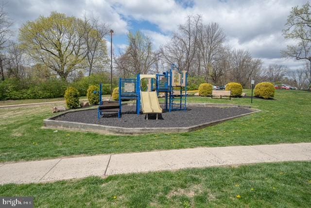 communal playground featuring a yard