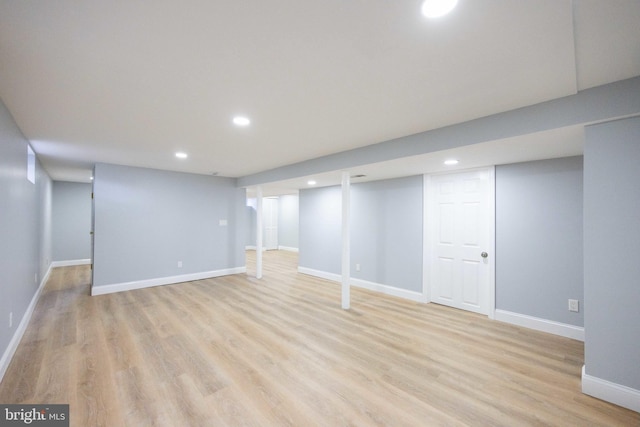 finished basement featuring recessed lighting, light wood finished floors, and baseboards