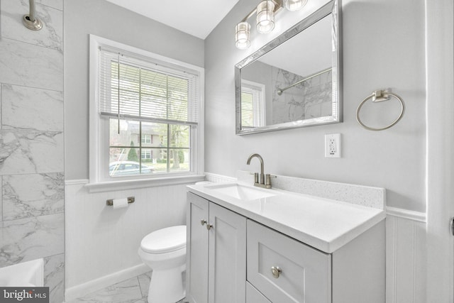 full bathroom featuring a shower, vanity, marble finish floor, and wainscoting