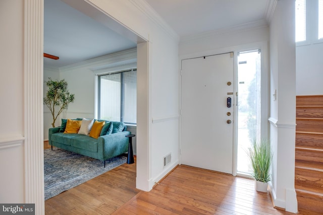 foyer entrance featuring light wood-style flooring, visible vents, and plenty of natural light