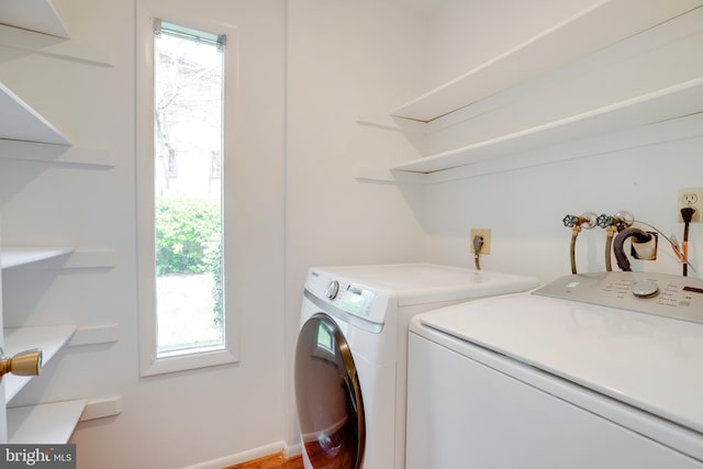 laundry room with baseboards, washer and dryer, plenty of natural light, and laundry area