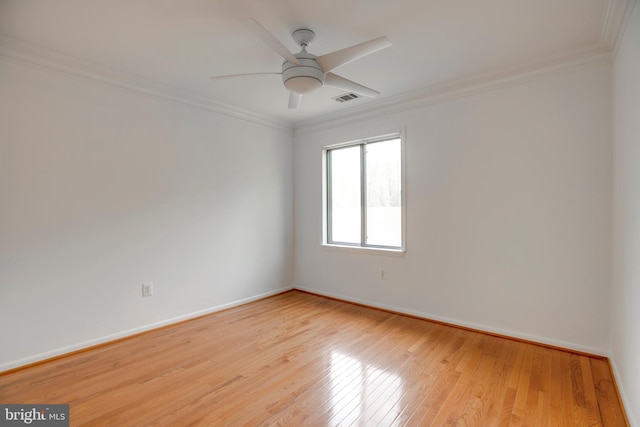 unfurnished room featuring visible vents, baseboards, ceiling fan, crown molding, and light wood-style flooring