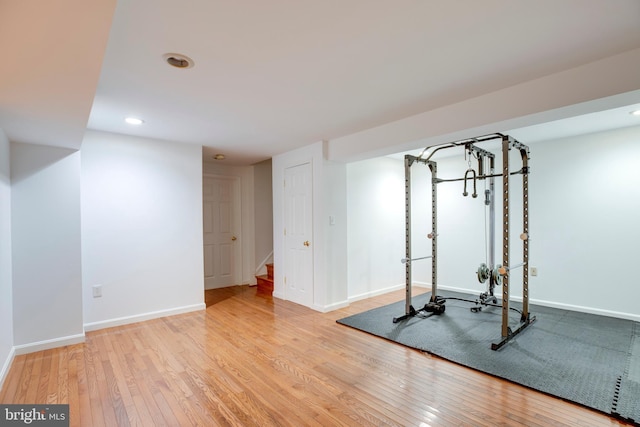 workout area featuring baseboards, recessed lighting, and hardwood / wood-style flooring