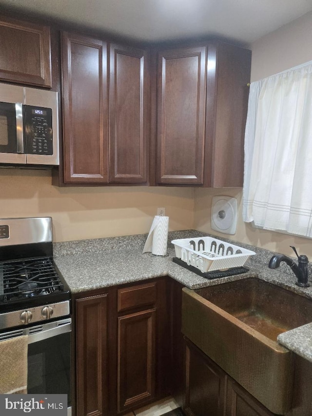 3660 Academy Rd, Philadelphia, PA 19154 - kitchen featuring stainless steel appliances, a sink, and dark brown cabinets