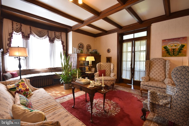 living room with beamed ceiling, radiator, coffered ceiling, and wood finished floors