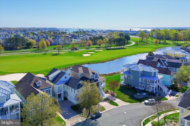 aerial view with view of golf course, a residential view, and a water view
