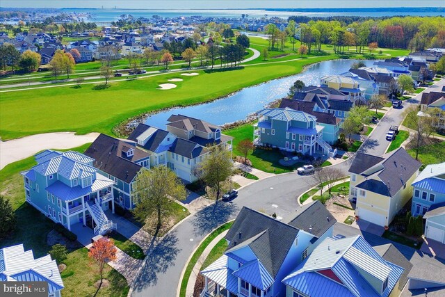 drone / aerial view featuring a water view and a residential view