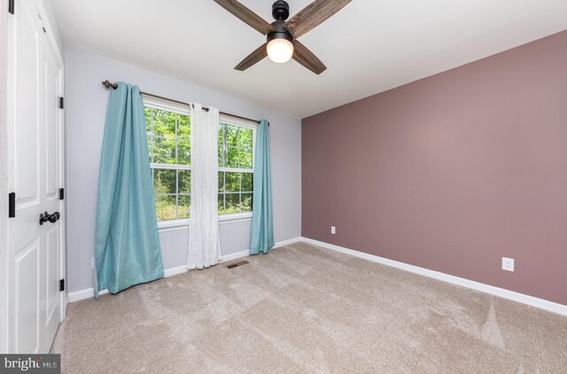 7464 Cedar Fork Rd, Ruther Glen, VA 22546 - unfurnished room with light colored carpet, baseboards, ceiling fan, and visible vents