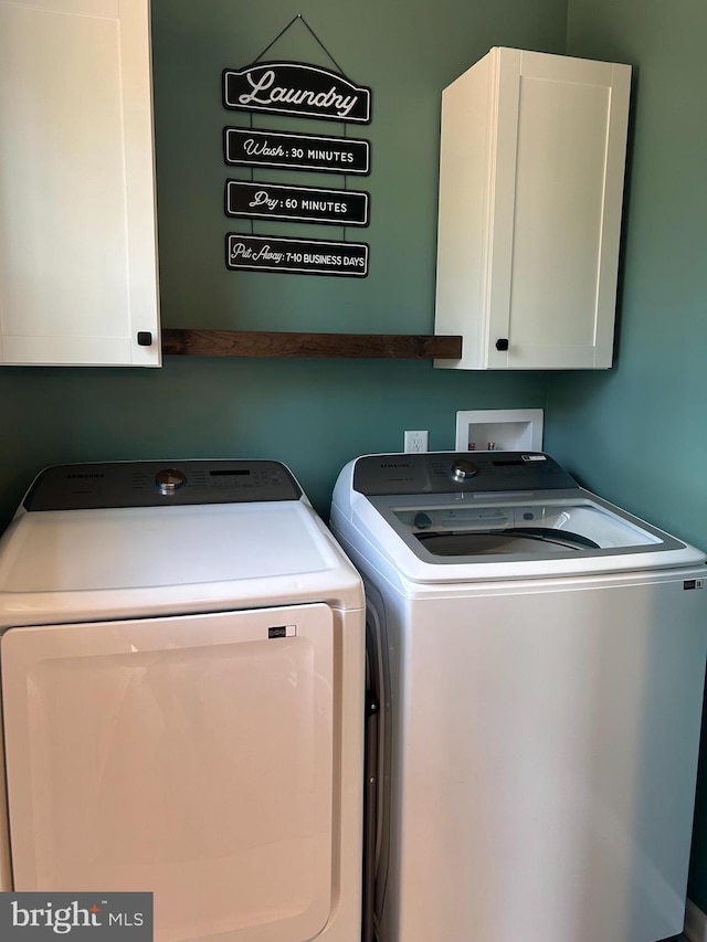 7464 Cedar Fork Rd, Ruther Glen, VA 22546 - laundry area with cabinet space and washing machine and dryer