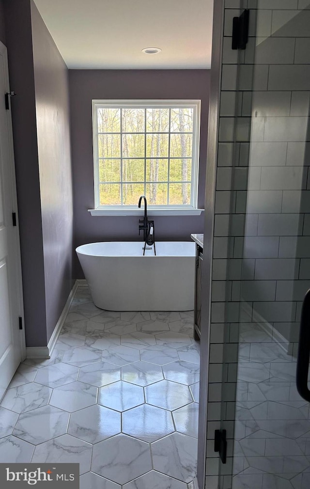 7464 Cedar Fork Rd, Ruther Glen, VA 22546 - bathroom with marble finish floor, recessed lighting, baseboards, a shower stall, and a soaking tub